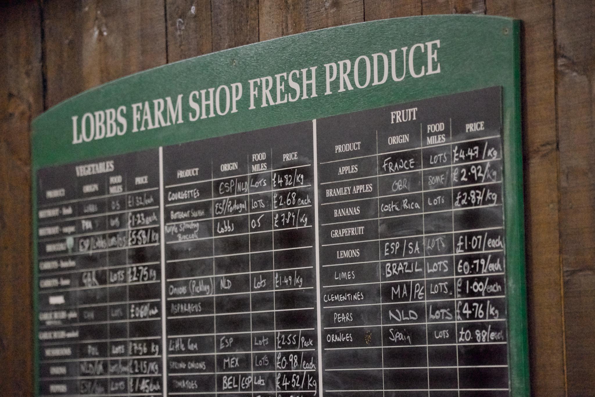 Chalkboard listing fresh produce prices at Lobbs Farm Shop