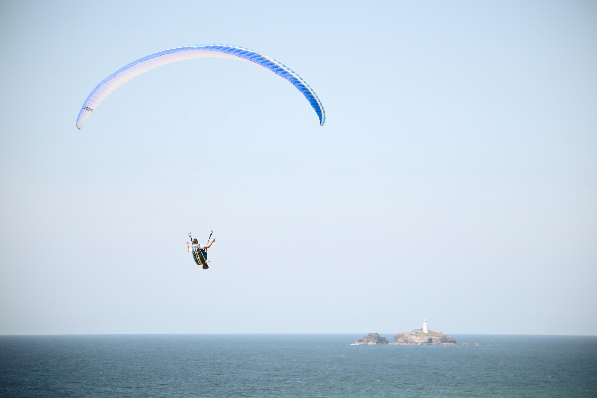 Paraglider over the sea, Godrevy lighthouse in the distance