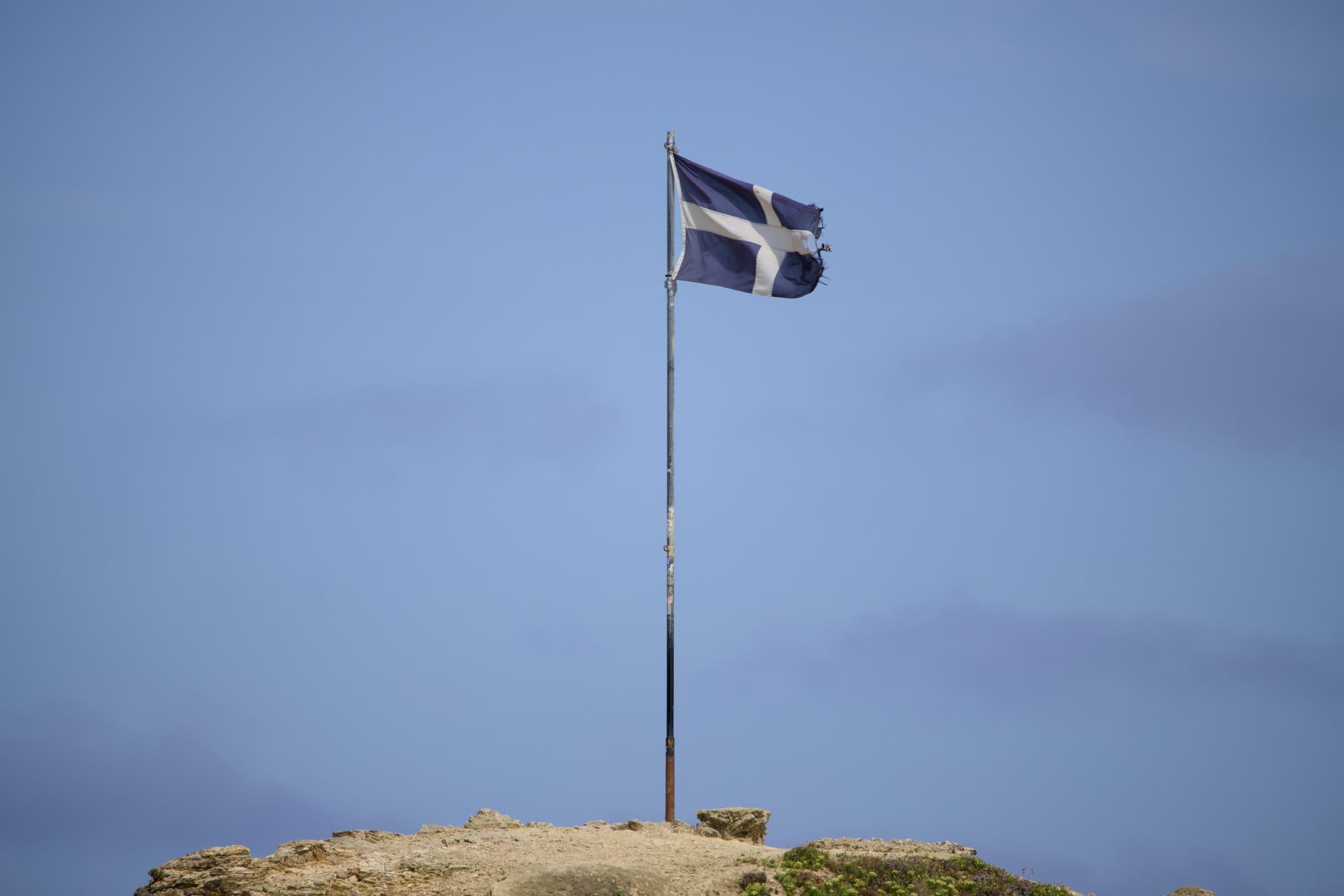 Cornish flag on a pole on top of the headland