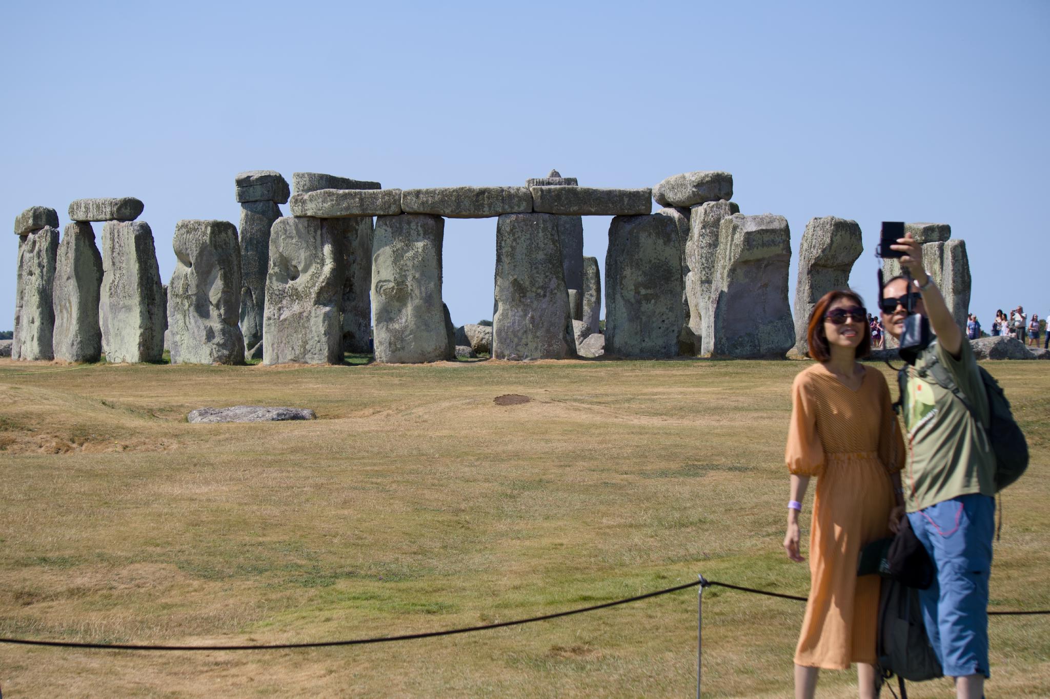 Couple taking a selfie in front of Stonehenge
