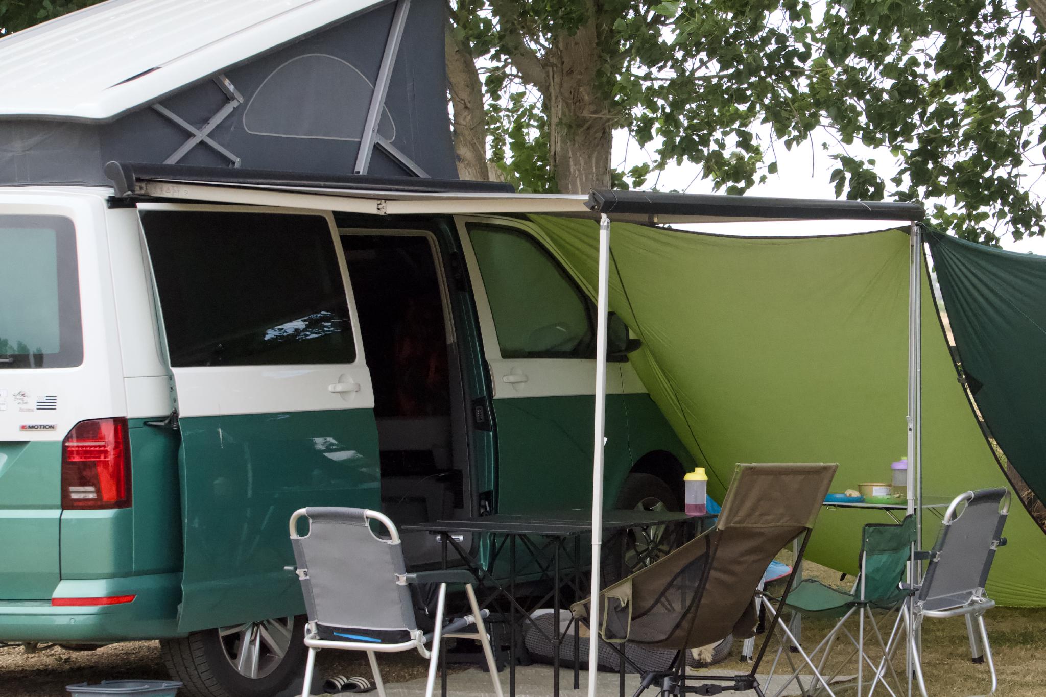 California with the roof up and awning out under a tree