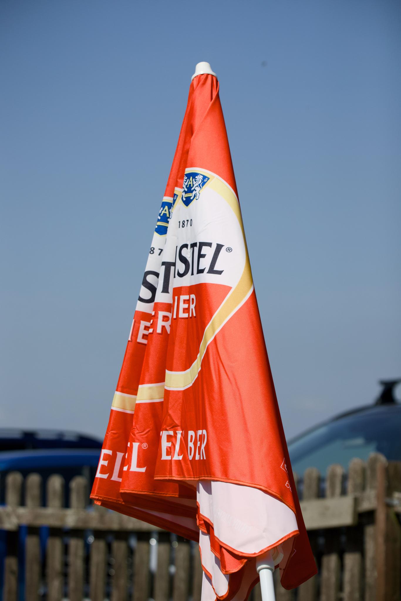 Folded Kastel Bier parasol against blue sky