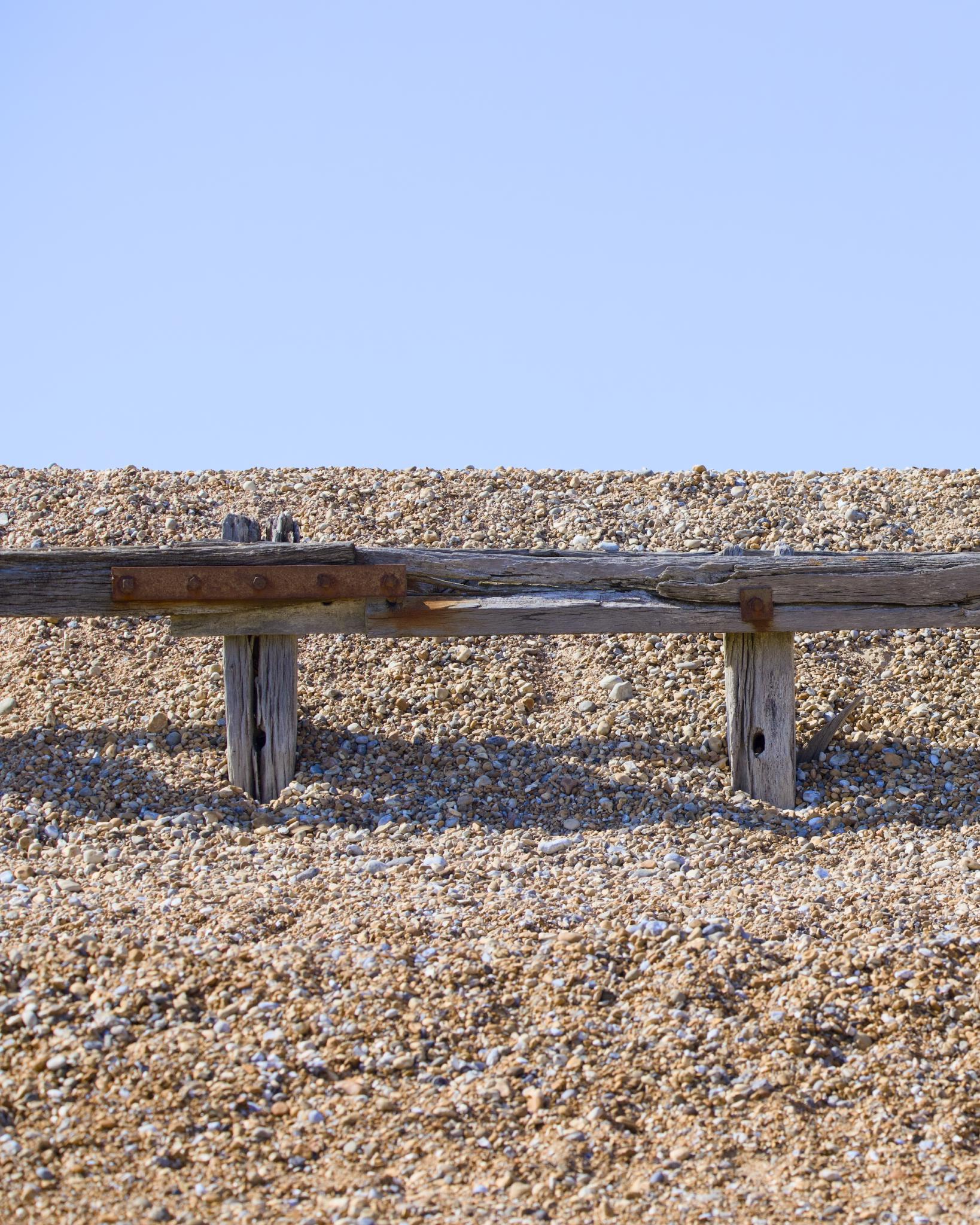 Weathered wooden groyne on a shingle beach