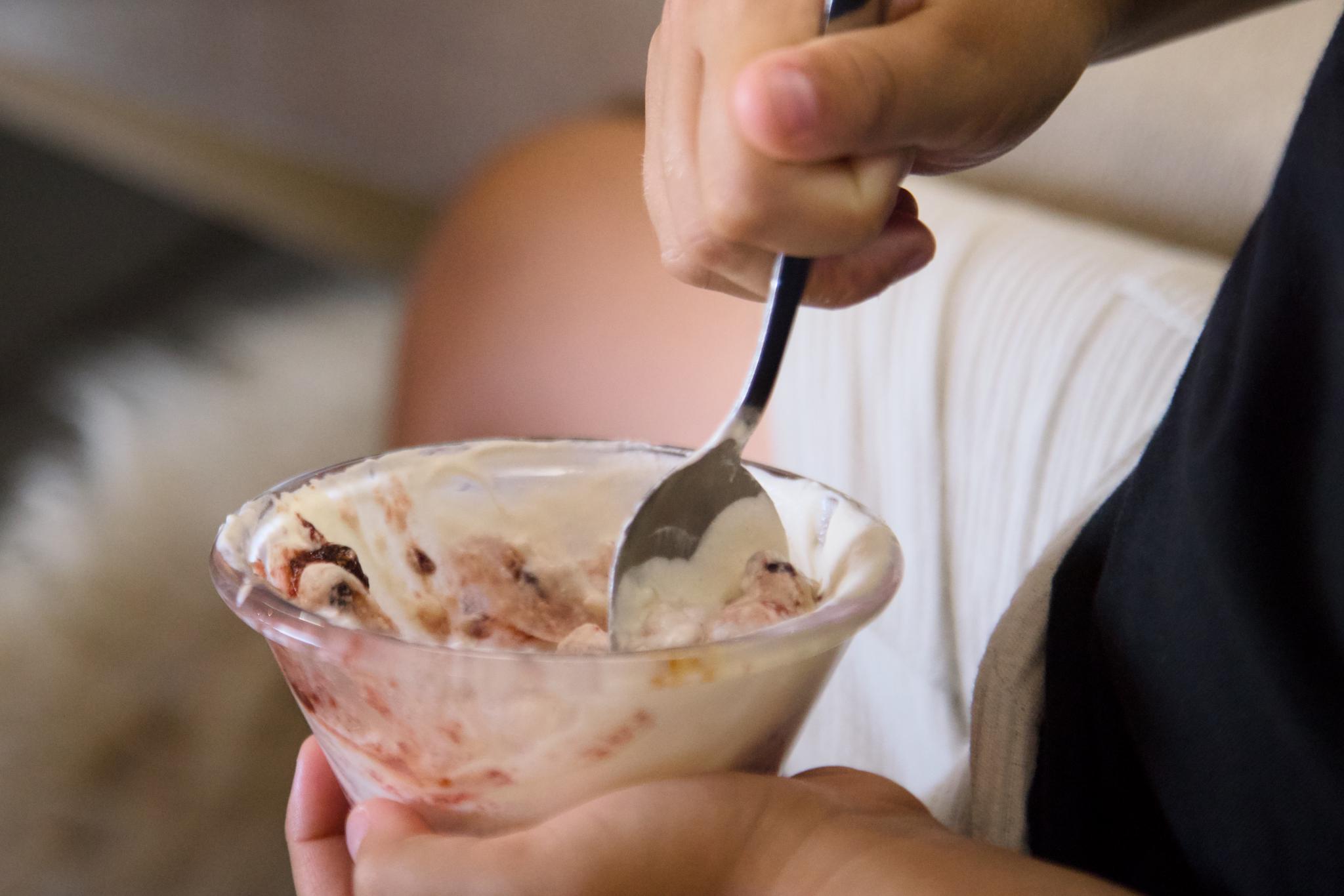 Bowl of ice cream in a kid's hands