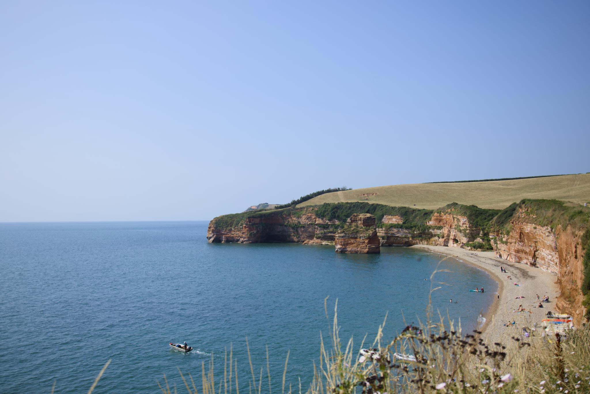 Ladram Bay from the cliff top, red sandstone cliffs and the sea stack in the bay