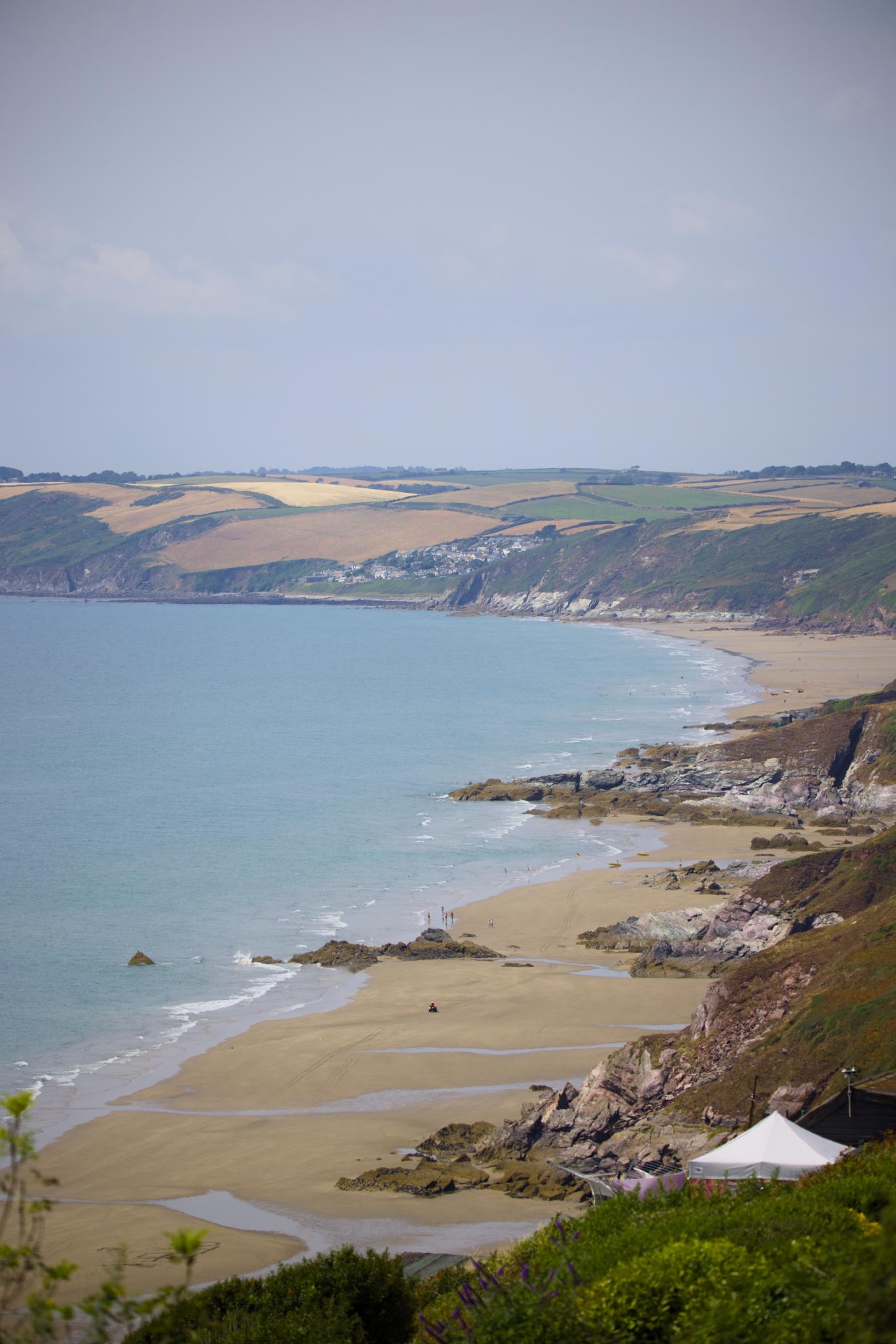 Long sandy beach of Whitsand Bay below the cliffs