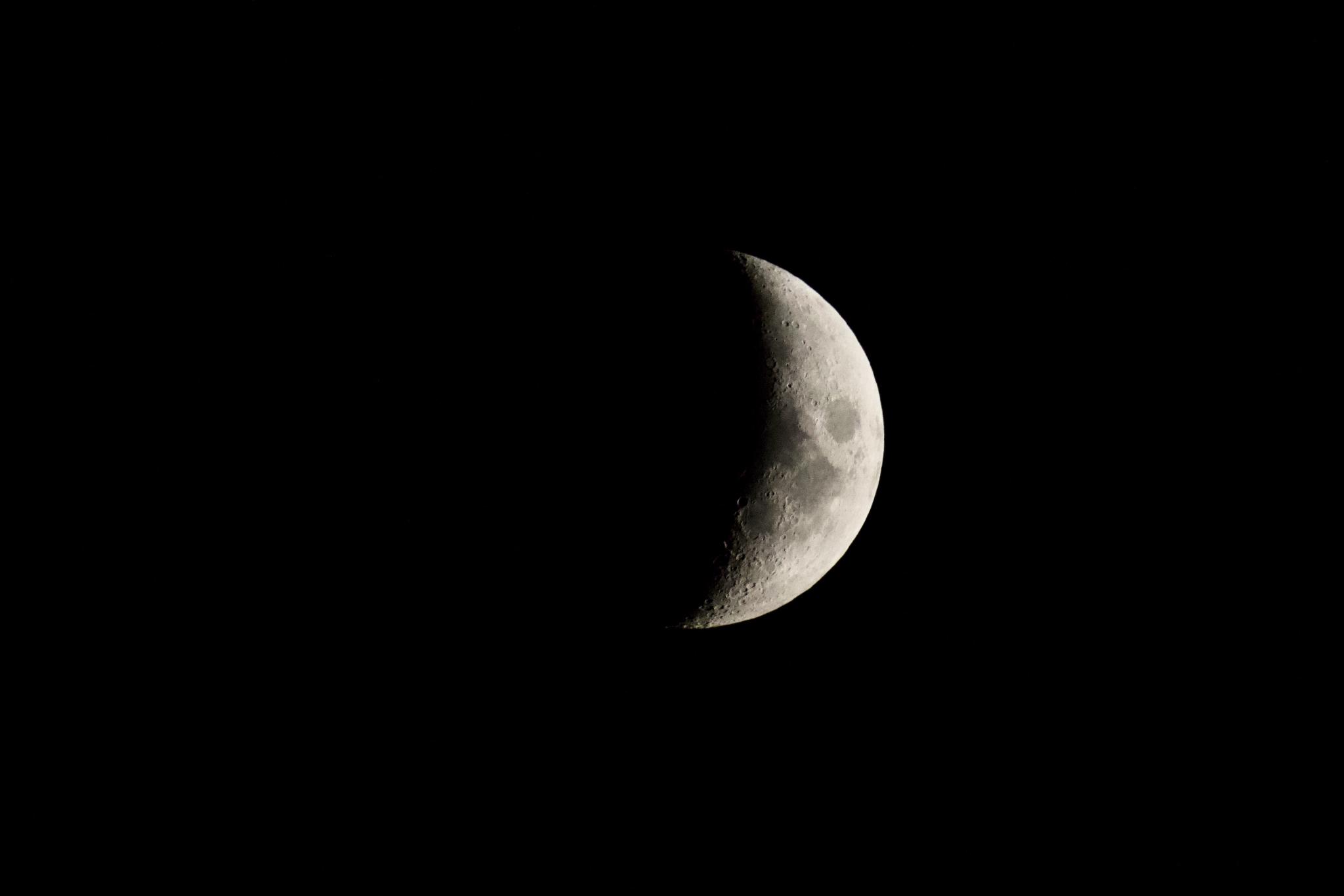 Waxing crescent moon against the black night sky