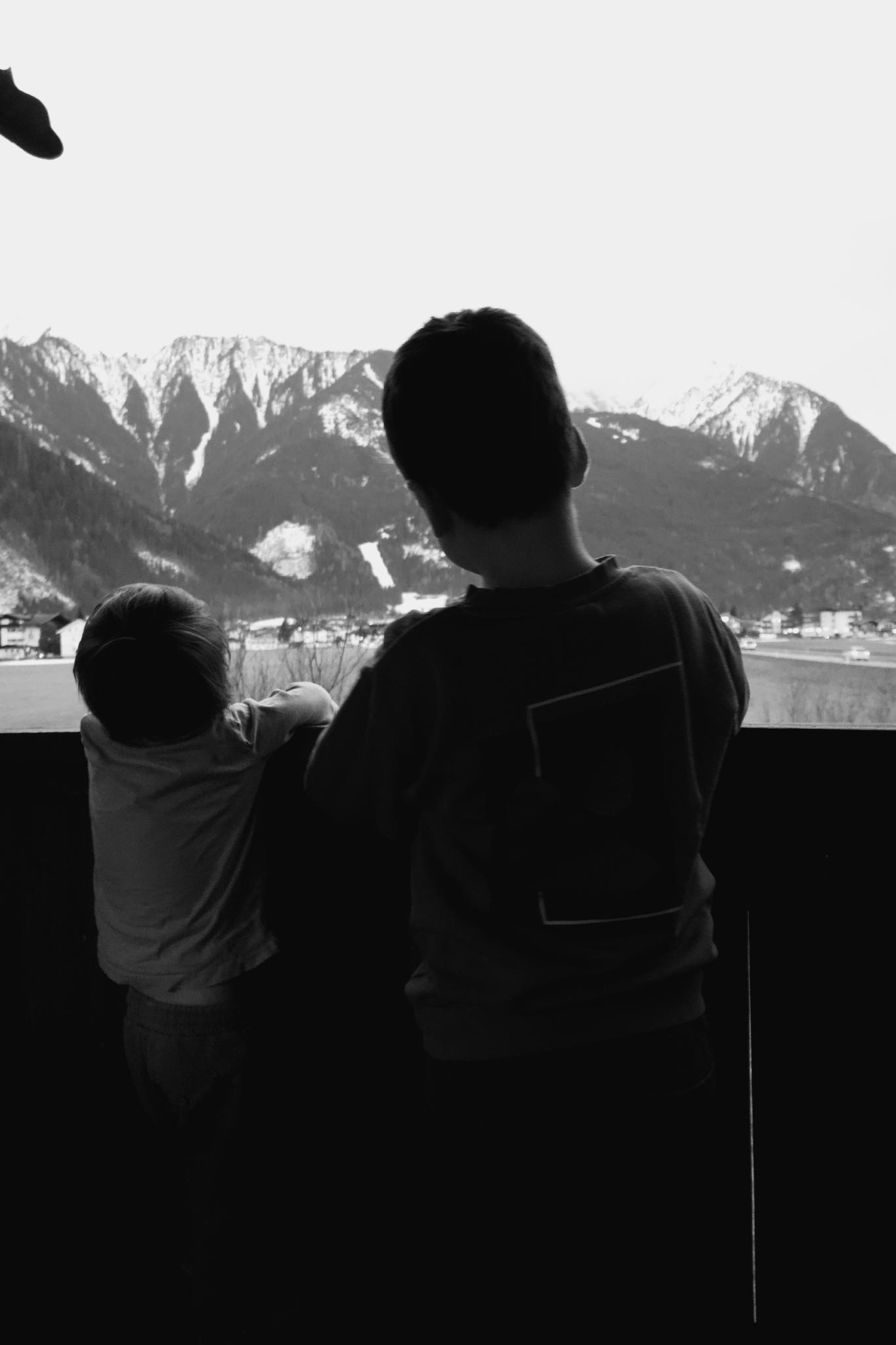 Two boys looking out from the balcony