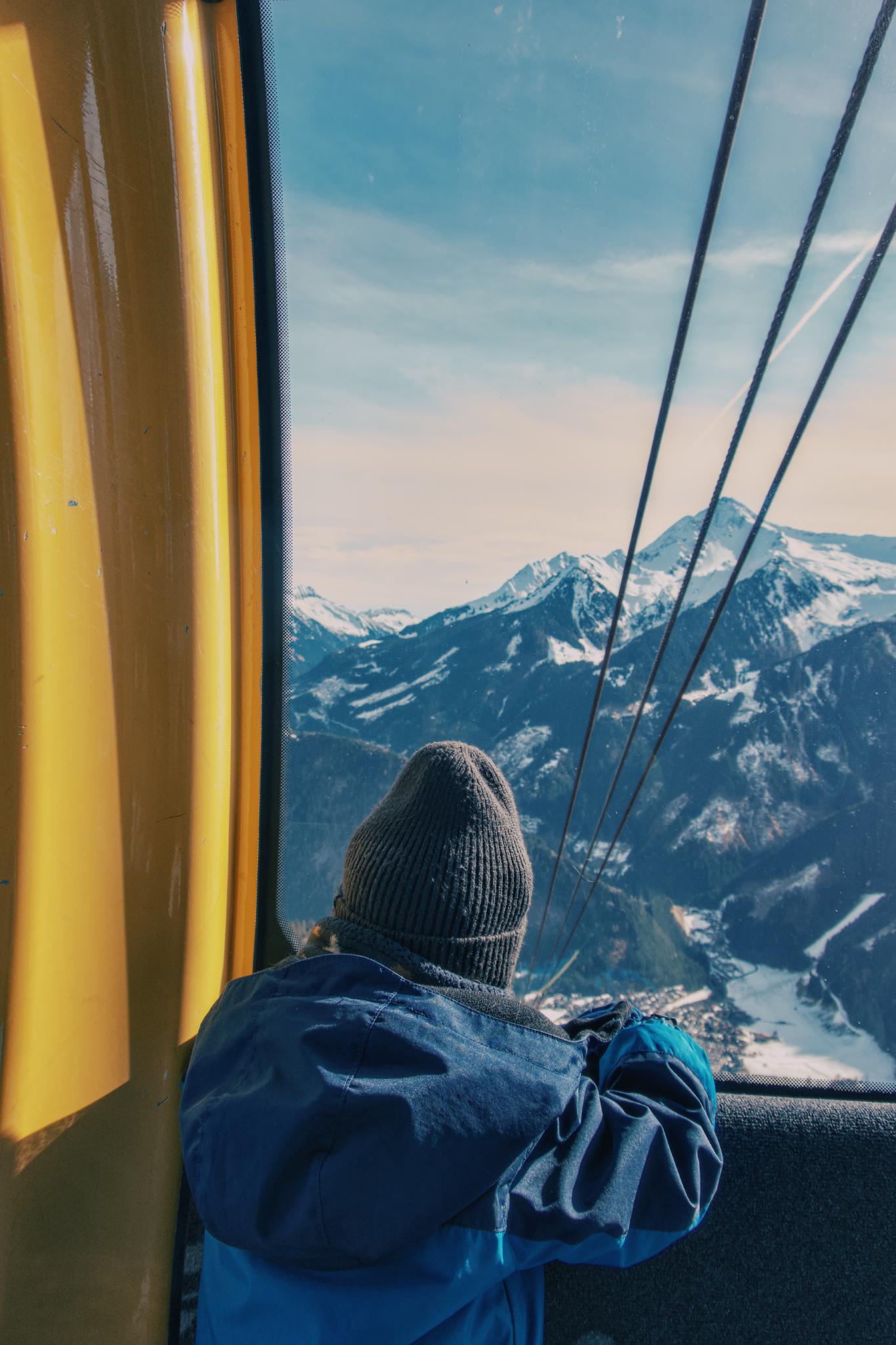 Portrait at the summit with mountains in the background