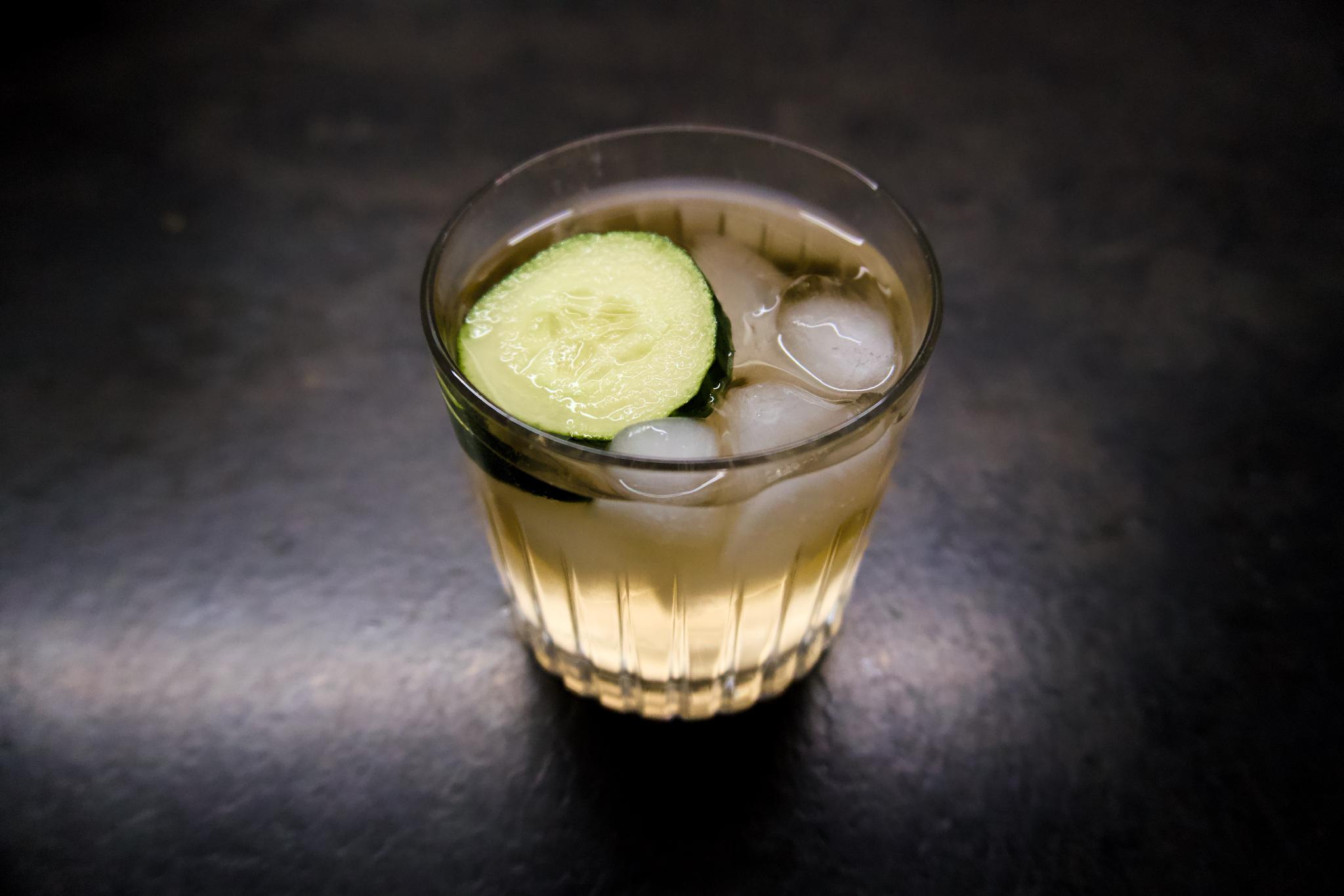 A virgin lemon gin and tonic with cucumber and ice in a glass