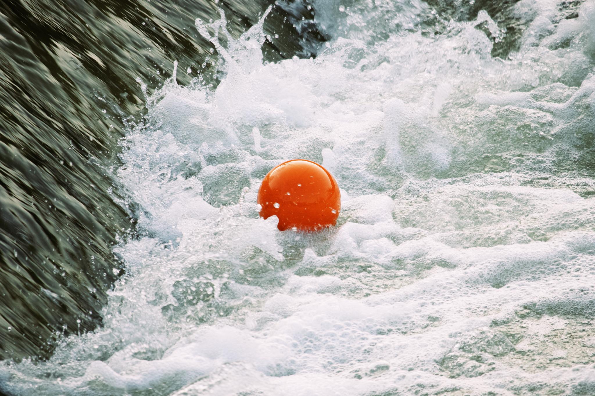 Orange ball trapped in the weir eddy