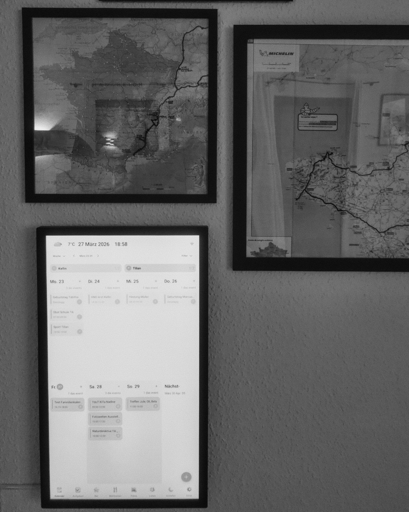 Dragon Touch 27 inch display showing a family calendar, integrated into a road trip map wall